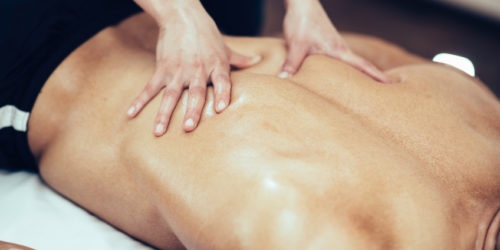 Physical therapist doing massage of male's back
